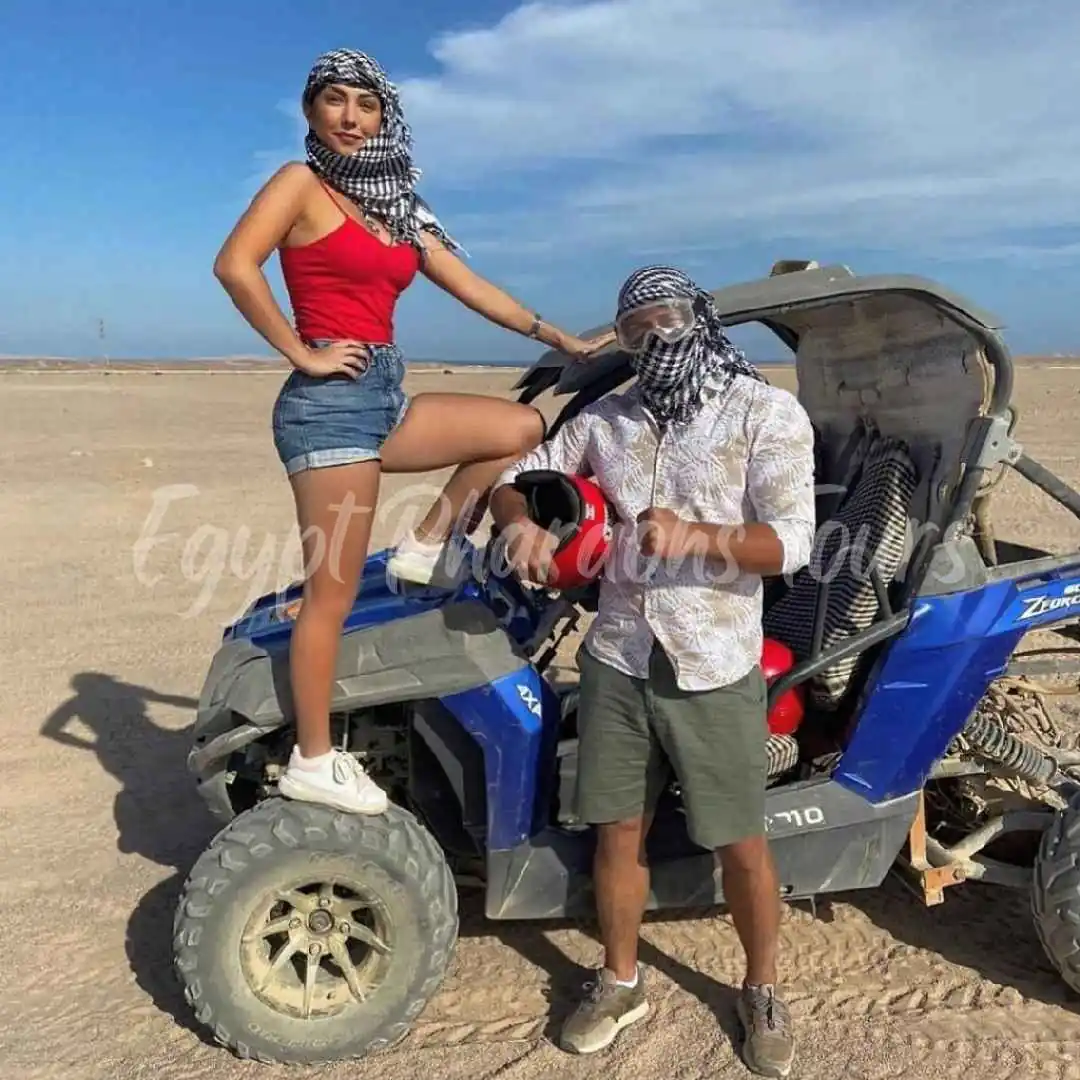 An open-air desert dune buggy racing over the sand on a guided Hurghada adventure tour