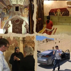 Private tour group walking outside the historic stone walls of the Saint Anthony Monastery in the Egypt desert.